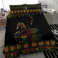 Black duvet cover with portrait graphic and multicolor text, framed by tribal border
