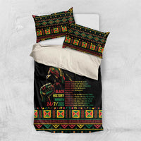 Black bedding set laid out with duvet and pillowcases featuring tribal geometric trim