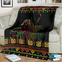 Black history blanket with colorful tribal stripes and portrait graphic, draped on couch
