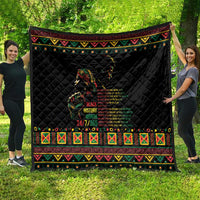 Black quilted blanket with colorful patterned trim and centered figure graphic