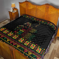 Black quilt on bed with diamond quilting and colorful banded edge