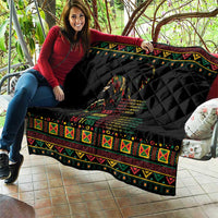 Black quilt with colorful patterned edge and centered figure graphic, quilted surface