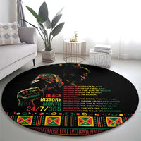 Black round rug with colorful tribal face graphic and centered slogan text