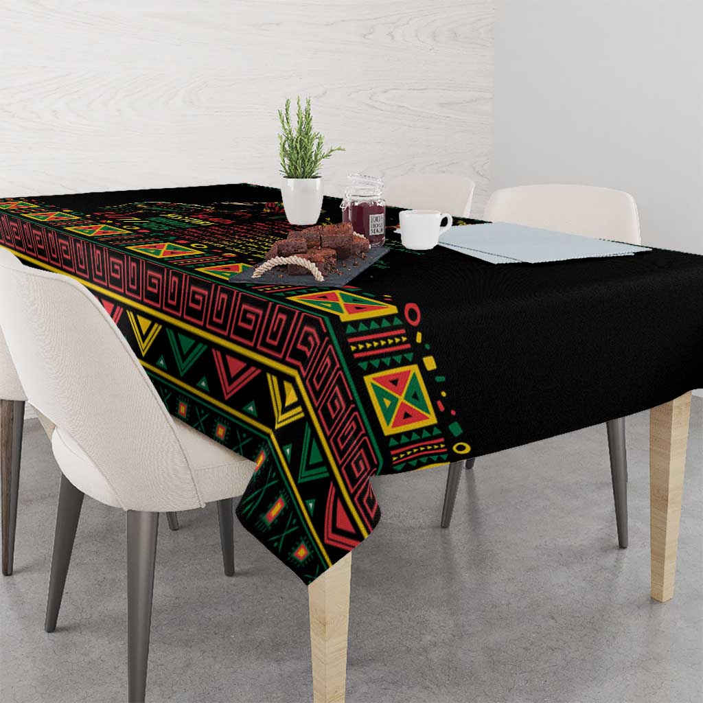 Black tablecloth with colorful geometric pattern draped over table corner
