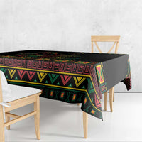 Black tablecloth with bold colorful border pattern on table front