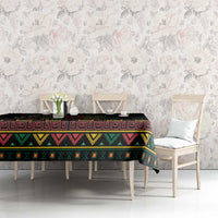 Black tablecloth with colorful geometric bands on dining table