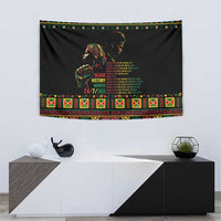 Black wall tapestry with portrait and Black History Month message, colorful patterned frame