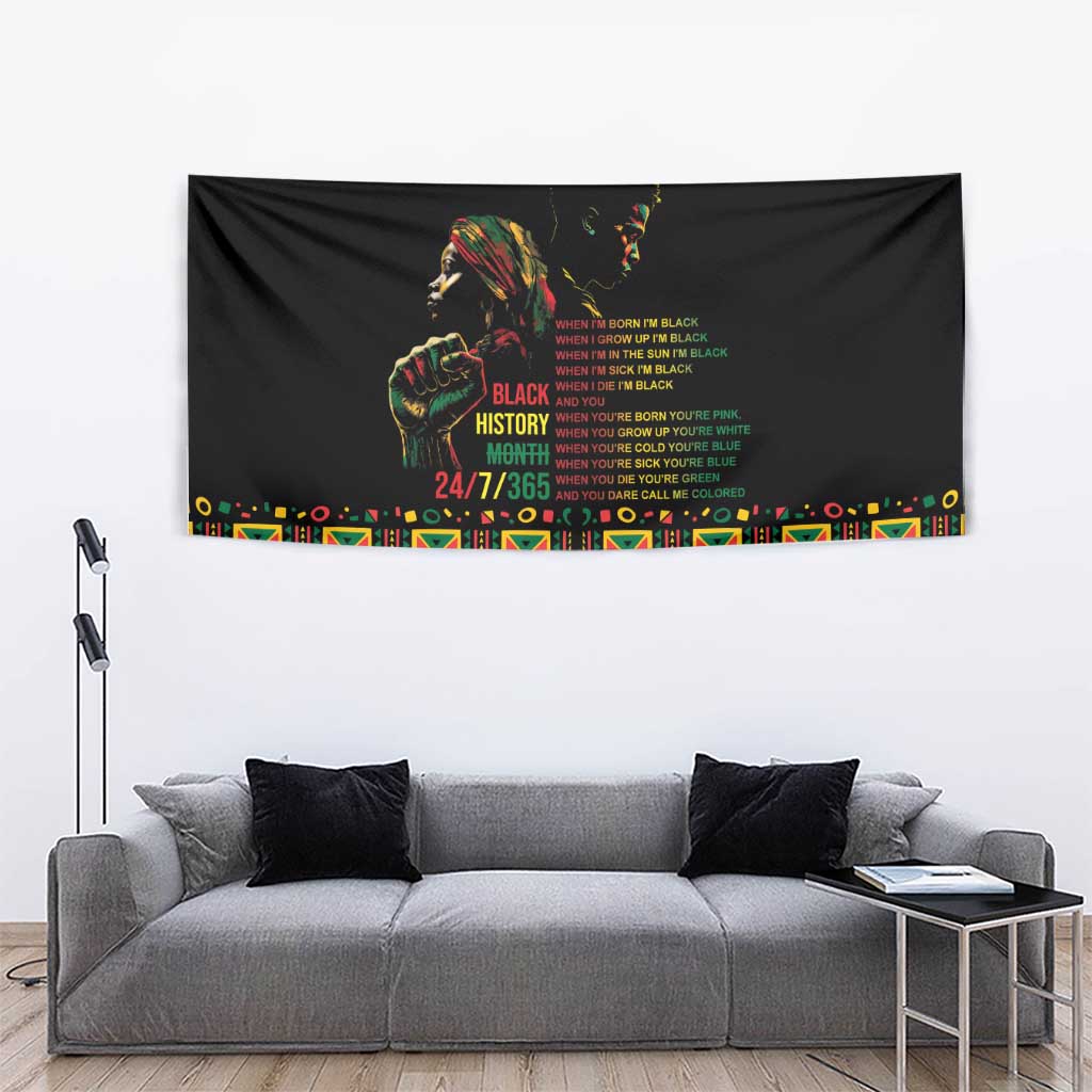 Black tapestry with portrait and Black History Month message, vibrant patterned edge