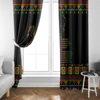 Black window curtain panels with multicolor trim and printed quote graphic beside window
