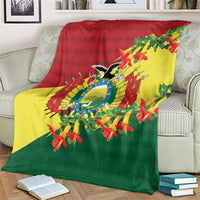 Tri-color condor and flower blanket draped over sofa back and arms
