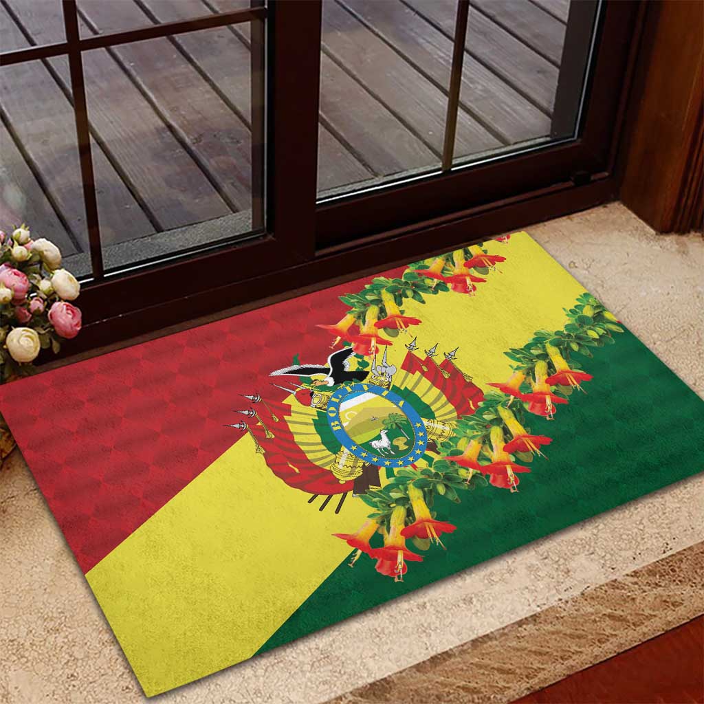 Rubber doormat at entry with Bolivia flag colors and condor center surrounded by kantuta