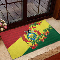 Rubber doormat at entry with Bolivia flag colors and condor center surrounded by kantuta