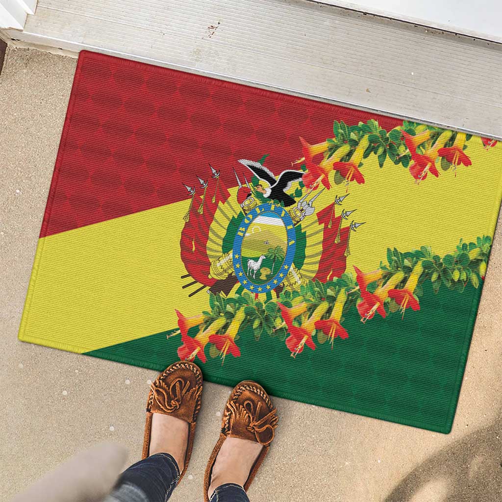 Rubber doormat on patio with Bolivia condor emblem and kantuta flowers, red yellow green
