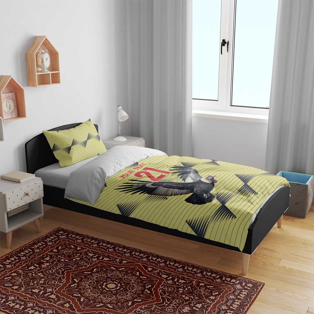 Yellow duvet with condor and 21 design, two matching pillowcases on a bed