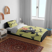 Yellow duvet with condor and 21 design, two matching pillowcases on a bed