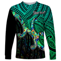 Unisex long sleeve Polynesian shirt in green and blue with koru and tribal patterns