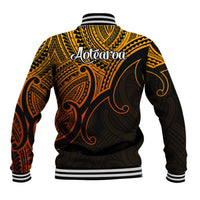 Unisex gold and black baseball jacket with Aotearoa script on back and striped ribbed cuffs