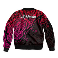 Black bomber jacket with pink Maori-style pattern and Aotearoa back graphic, ribbed hem