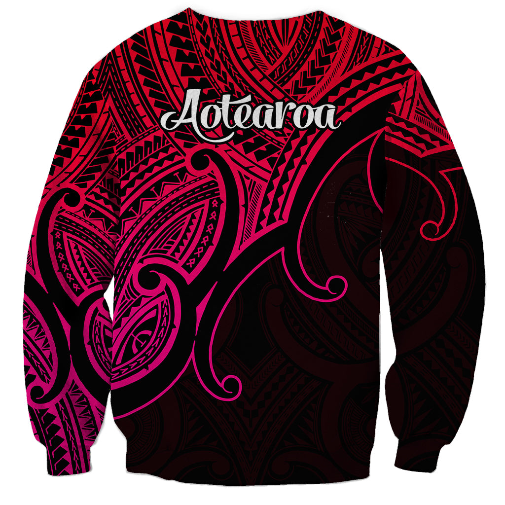 Unisex pink-and-black sweatshirt, 'Aotearoa' on back with koru tribal design