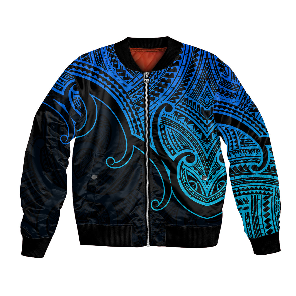 Blue bomber jacket with black zip, Maori-style koru tribal pattern and ribbed cuffs