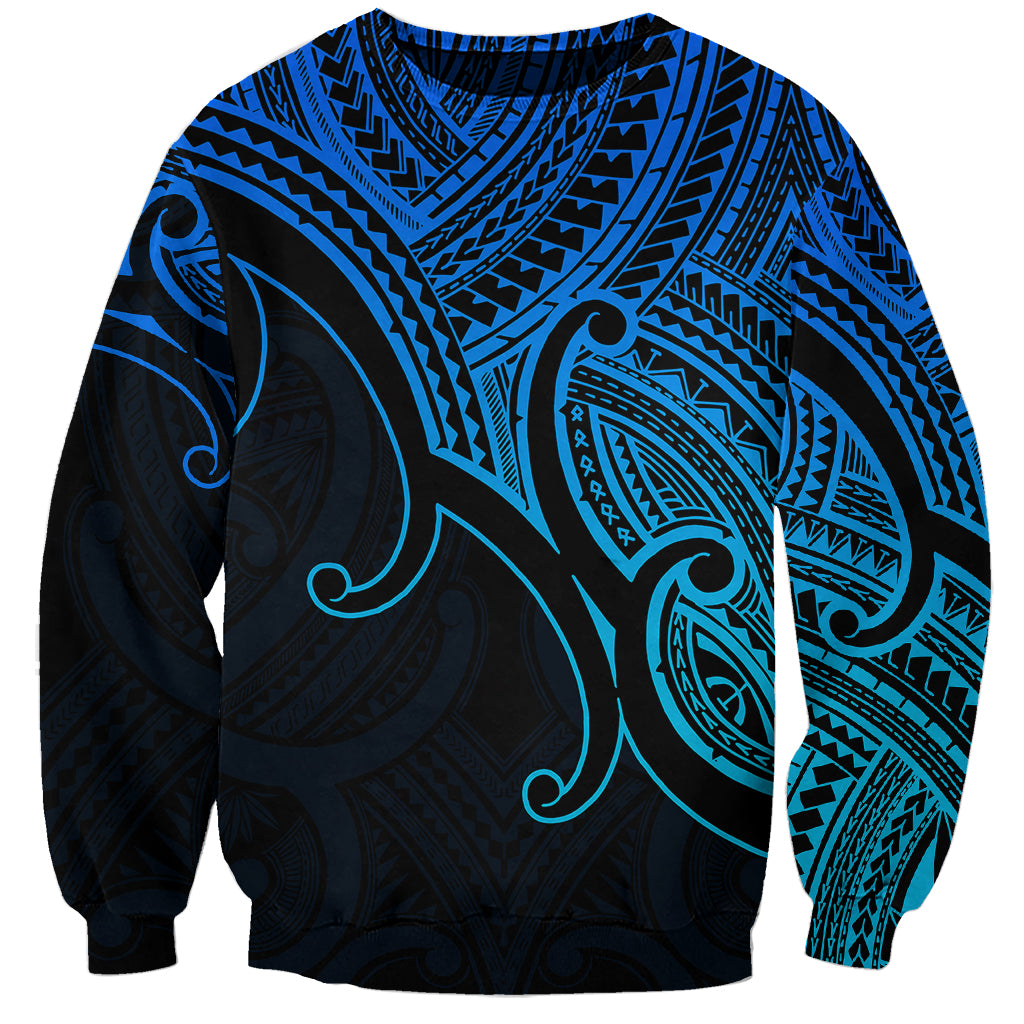 Blue crewneck sweatshirt with black-and-teal Polynesian tribal koru print, long sleeves
