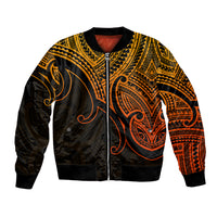 Gold and black bomber jacket with zip front, ribbed cuffs, Polynesian koru and tribal patterns