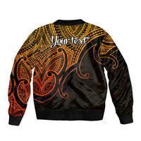 Gold and black bomber jacket with back print, ribbed hem and cuffs, tribal koru pattern