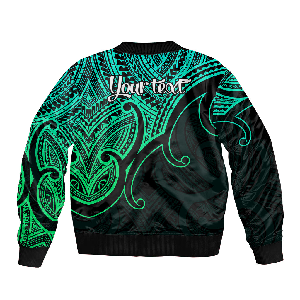 Green and black bomber jacket back with teal tribal pattern, ribbed hem, and 'Your text'