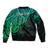 Green and black bomber jacket back with teal tribal pattern, ribbed hem, and 'Your text'