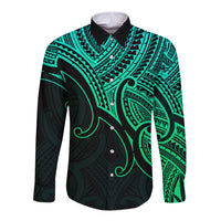 Green and black long sleeve button shirt with tribal pattern and black collar.