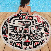 Round fringed beach blanket with Haida-style raven and tribal motifs in black, white, red
