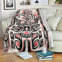 Haida-style throw blanket with red/black/white pattern and 'YOUR TEXT' print