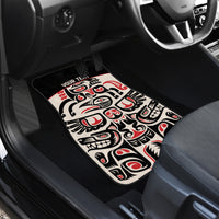 Personalized car floor mat with red, black, and white totem face design in tan border