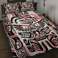 Quilt bed set close-up with black, white, red Haida-inspired animal and totem motifs