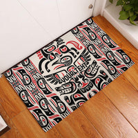 Personalized rubber doormat, angled view, Haida-style totem pattern in black, red, white.