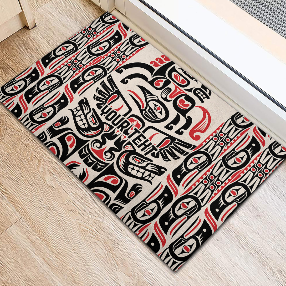 Personalized rubber doormat with centered Haida crest and totem motifs, black red white.