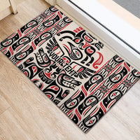 Personalized rubber doormat with centered Haida crest and totem motifs, black red white.
