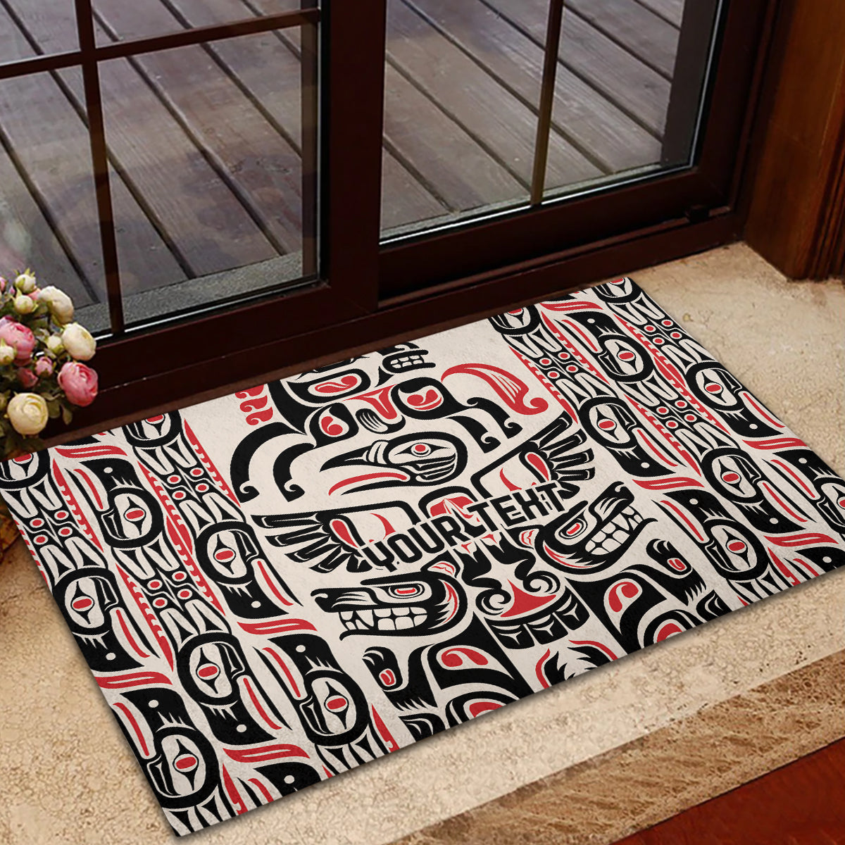 Personalized rubber doormat with Haida animal and totem designs in black, red, white.