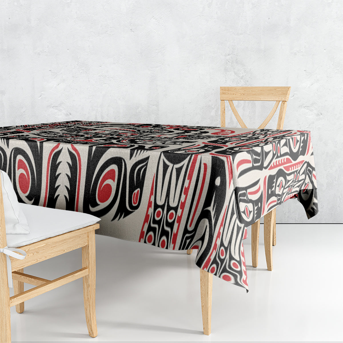 Personalized tablecloth on table with black, red, and white Haida-style motif