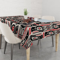 Personalized tablecloth on table with bold black and red Haida-style graphic pattern