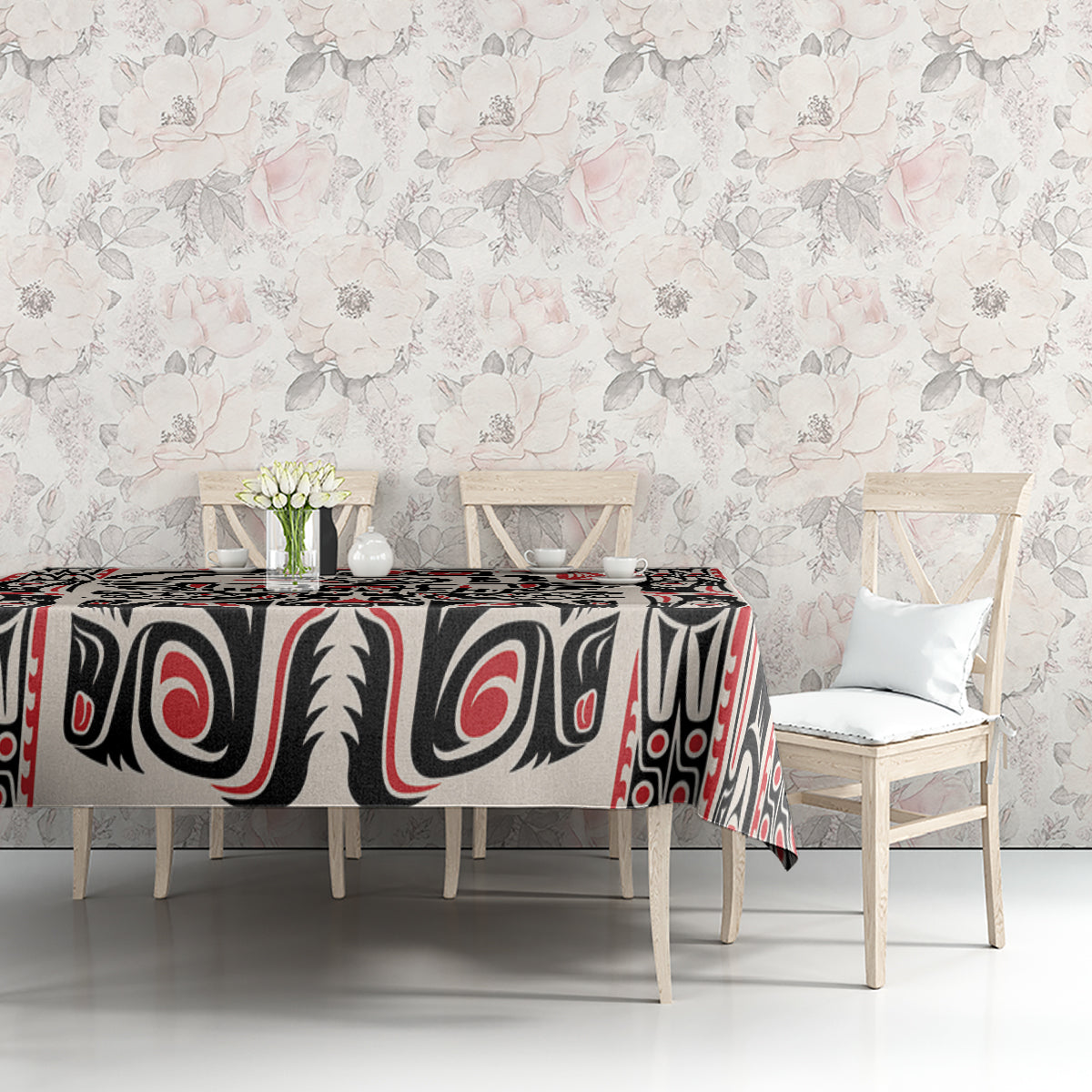 Personalized tablecloth on dining table with black, red, and white Haida-style pattern
