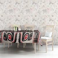 Personalized tablecloth on dining table with black, red, and white Haida-style pattern