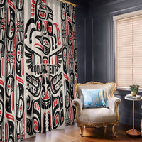 Haida art window curtain panels in red black white, hanging beside an accent armchair