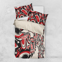 Personalized bedding set laid flat with red, black, and white tribal duvet and two pillows