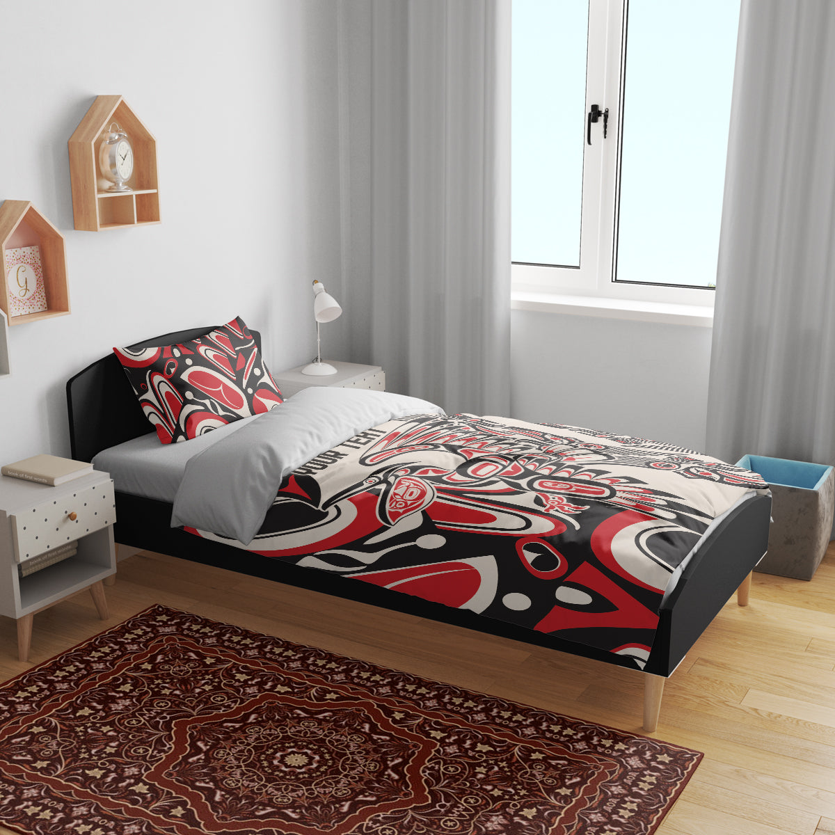 Personalized bedding set on bed with red, black, and white tribal duvet and matching pillow