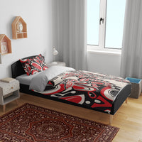 Personalized bedding set on bed with red, black, and white tribal duvet and matching pillow