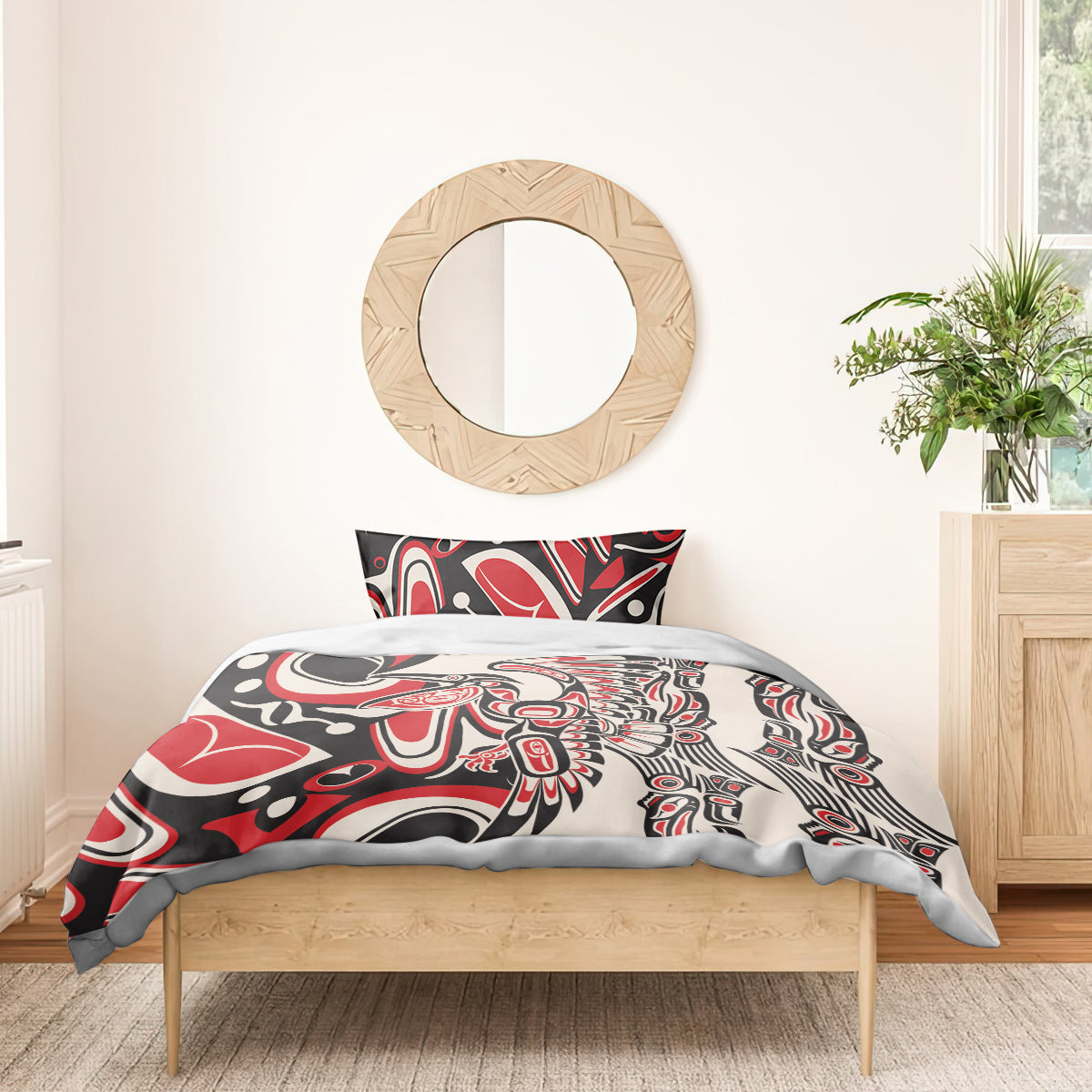 Personalized bedding set on a bed with red, black, and white tribal comforter and pillow