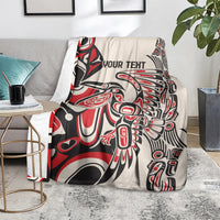 Personalized throw blanket draped on sofa, red/black/white bold abstract design with 'YOUR TEXT'