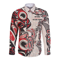Red, black and cream long sleeve button-up shirt with front graphic badge