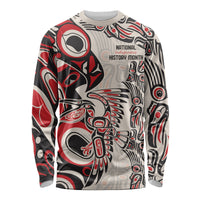 Unisex long-sleeve shirt with Indigenous-inspired red, black, and gray pattern and text